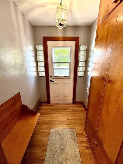 entryway featuring an inviting chandelier and light wood-type flooring