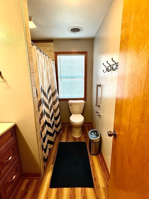 bathroom with vanity, toilet, hardwood / wood-style flooring, and a shower with curtain