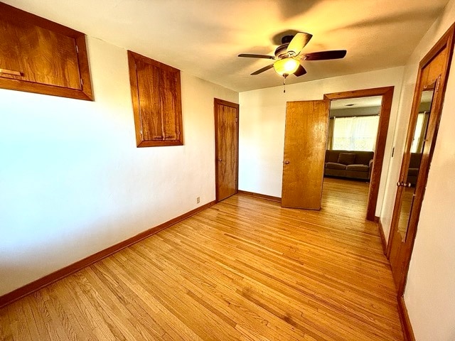 unfurnished bedroom with light hardwood / wood-style floors and ceiling fan