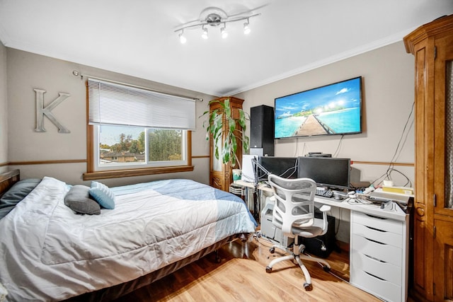 bedroom featuring crown molding and hardwood / wood-style floors