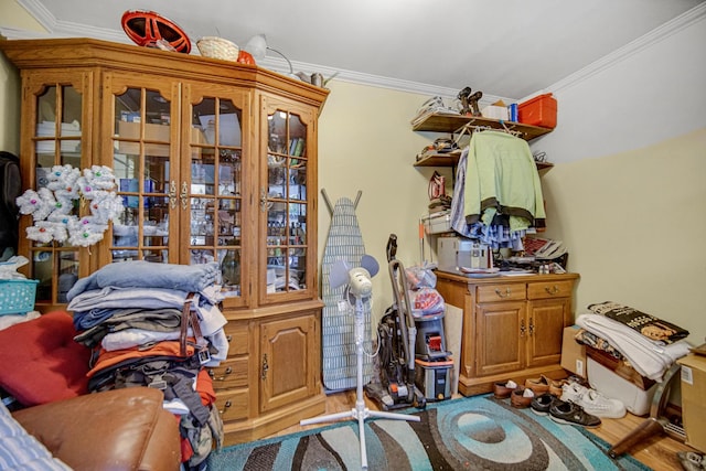 interior space with ornamental molding and hardwood / wood-style floors