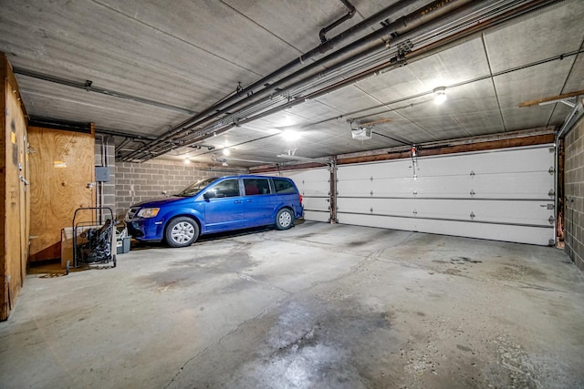 garage featuring a garage door opener and a carport