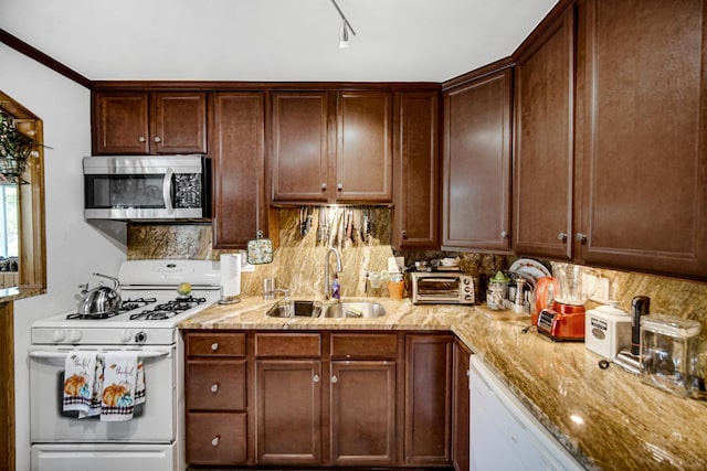 kitchen with rail lighting, tasteful backsplash, white appliances, light stone countertops, and sink