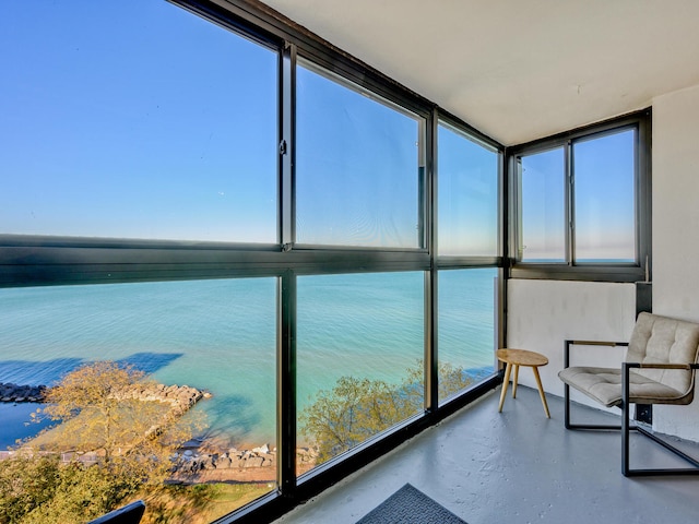 sunroom / solarium featuring a water view