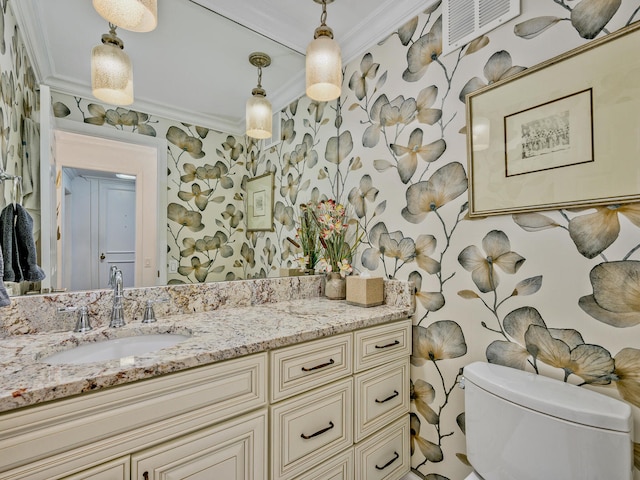 bathroom featuring vanity, crown molding, and toilet