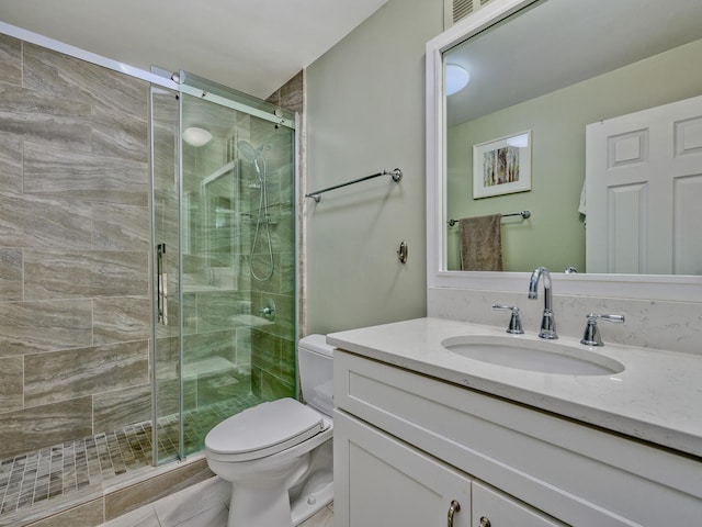 bathroom with vanity, toilet, walk in shower, and tile patterned flooring