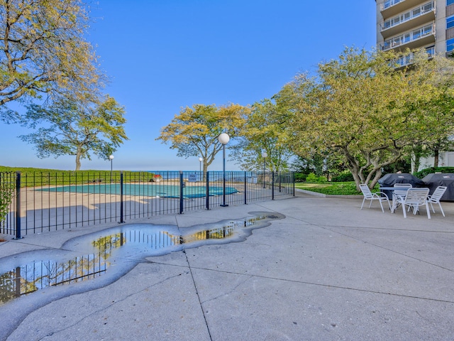 exterior space with a water view and a patio area