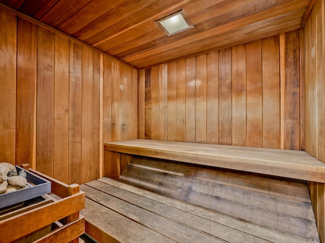 view of sauna / steam room with wood ceiling and wood walls