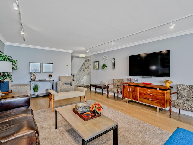 living room featuring hardwood / wood-style floors, track lighting, and crown molding