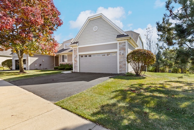 view of front of home featuring a front lawn and a garage