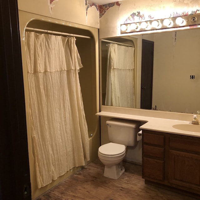 bathroom featuring curtained shower, hardwood / wood-style floors, vanity, and toilet