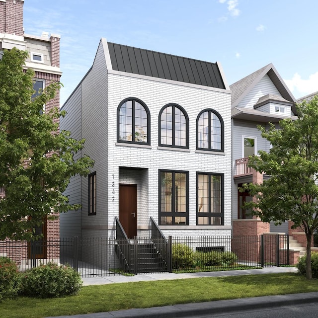 1342 W Wellington Ave, Chicago, IL 60657 - view of front facade featuring brick siding, a fenced front yard, and entry steps