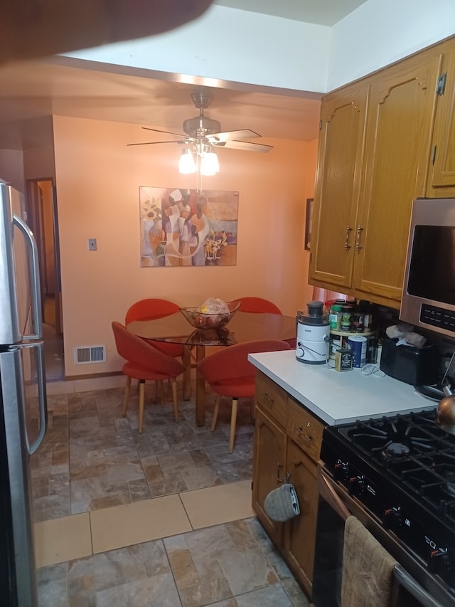 kitchen featuring appliances with stainless steel finishes and ceiling fan