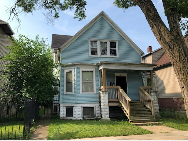 view of front of house featuring a front yard and covered porch