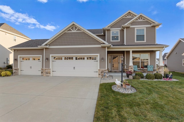 craftsman house with a front yard, a garage, and a porch