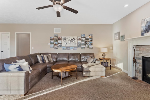 carpeted living room featuring ceiling fan and a fireplace