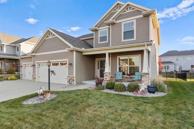 craftsman house featuring covered porch and a front yard