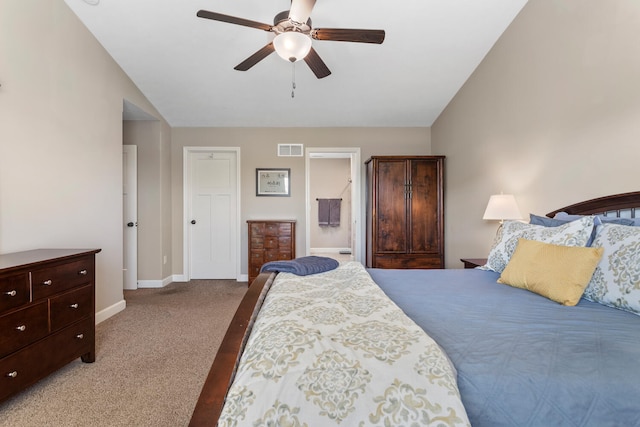 bedroom featuring carpet floors, ensuite bathroom, vaulted ceiling, and ceiling fan