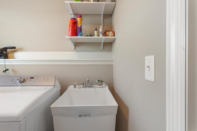 laundry area with washer / dryer and sink