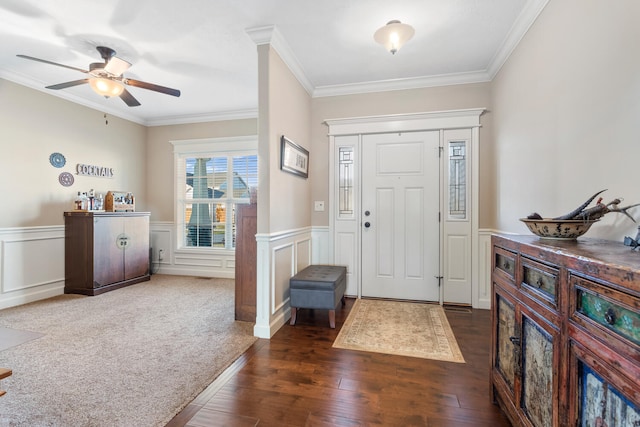 foyer entrance featuring ceiling fan, ornamental molding, and dark hardwood / wood-style flooring