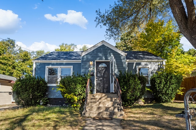 bungalow-style house with a front yard