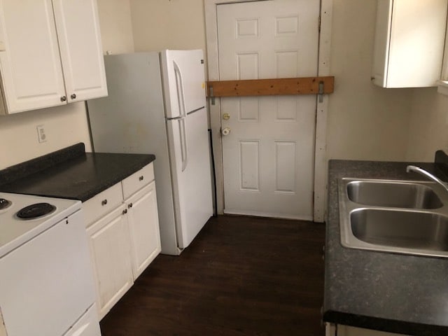 kitchen featuring sink, white cabinetry, dark wood-type flooring, and white appliances