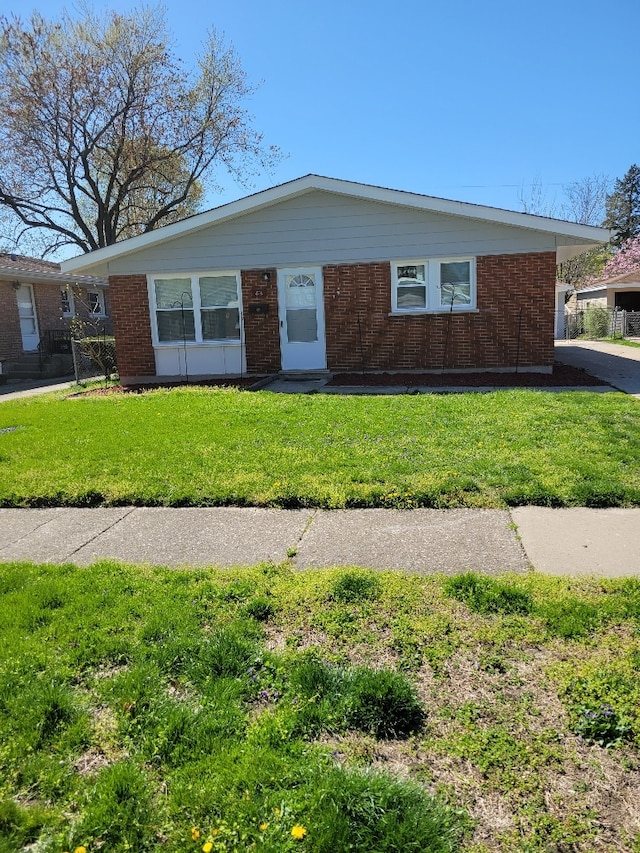 ranch-style home with a front lawn