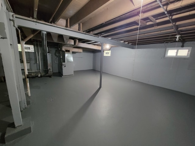 basement featuring heating unit and gas water heater