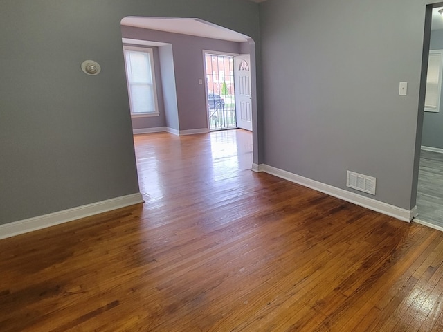 unfurnished room with hardwood / wood-style flooring