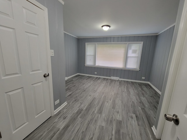 spare room with crown molding and light hardwood / wood-style flooring