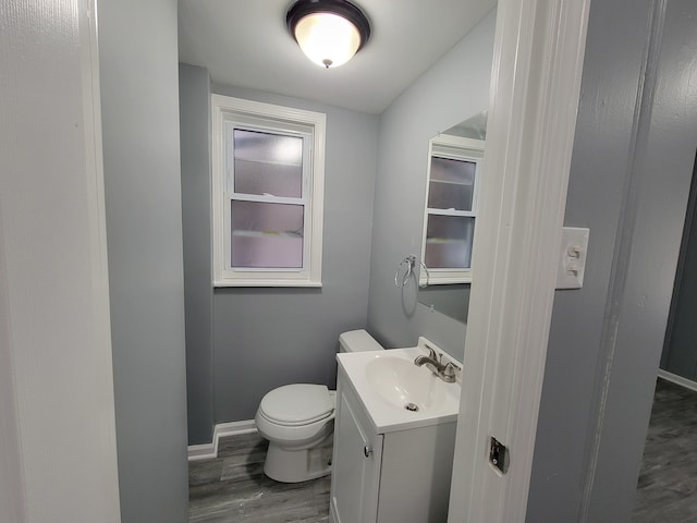 bathroom featuring vanity, toilet, and hardwood / wood-style floors