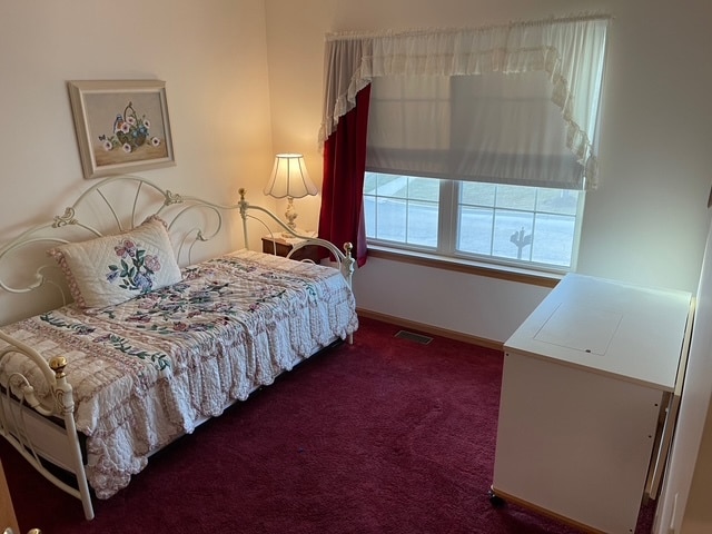 bedroom featuring dark carpet