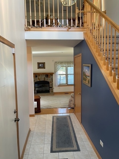 hallway featuring tile patterned floors and a high ceiling