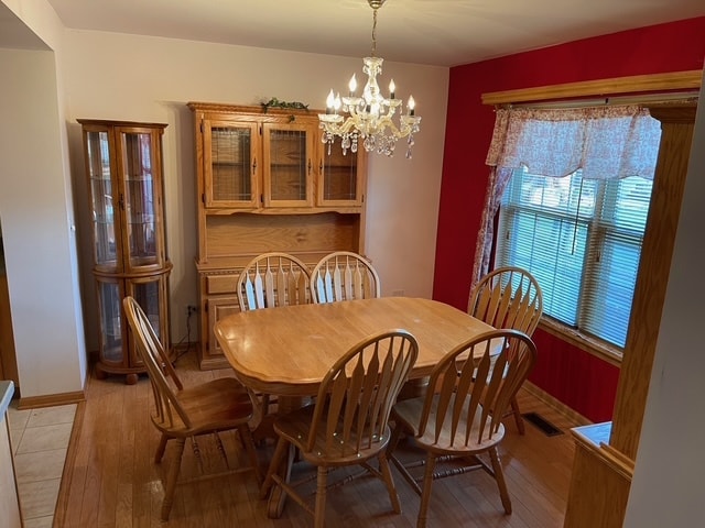 dining room featuring a chandelier and light hardwood / wood-style flooring