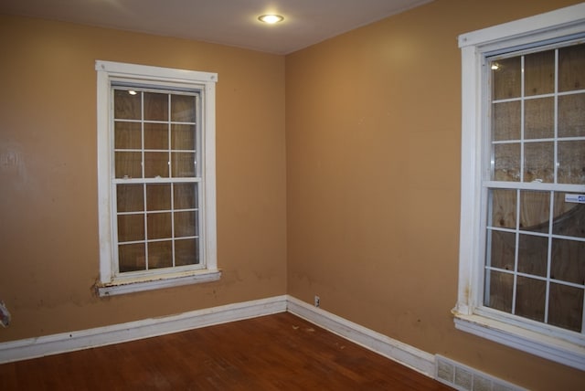 unfurnished room with hardwood / wood-style flooring