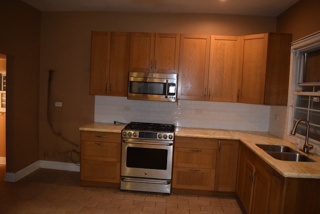 kitchen featuring sink, appliances with stainless steel finishes, and decorative backsplash