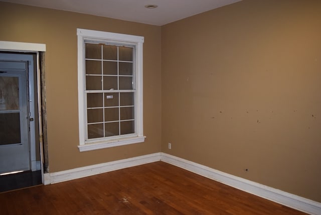 empty room with hardwood / wood-style floors