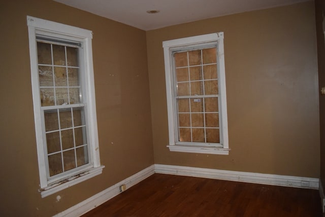 unfurnished room featuring dark hardwood / wood-style flooring