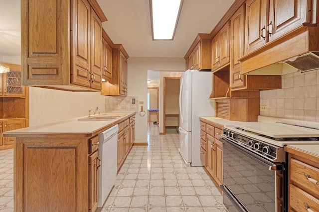 kitchen with white appliances, tasteful backsplash, and sink