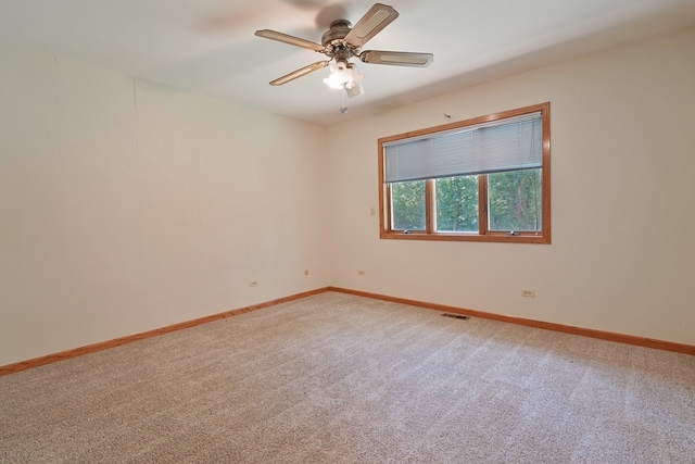 spare room with carpet floors and ceiling fan