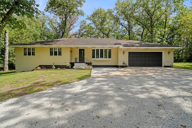 ranch-style home with a front yard and a garage