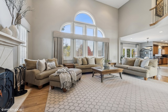 living room featuring a high ceiling and light wood-type flooring