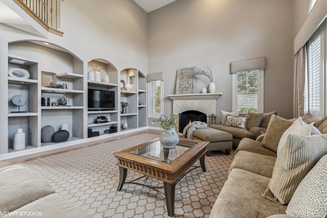 living room featuring a high ceiling and a wealth of natural light