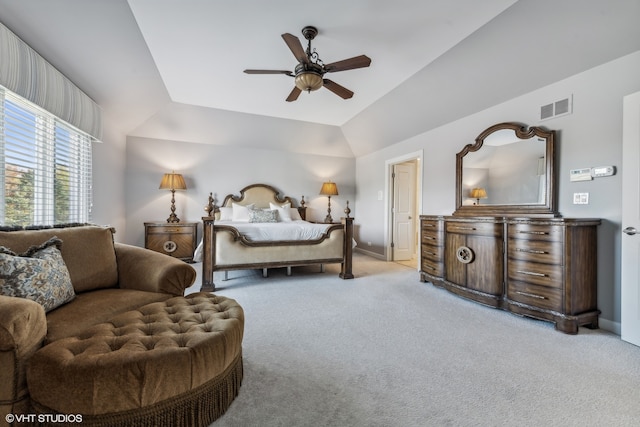 bedroom with ceiling fan, light carpet, and vaulted ceiling