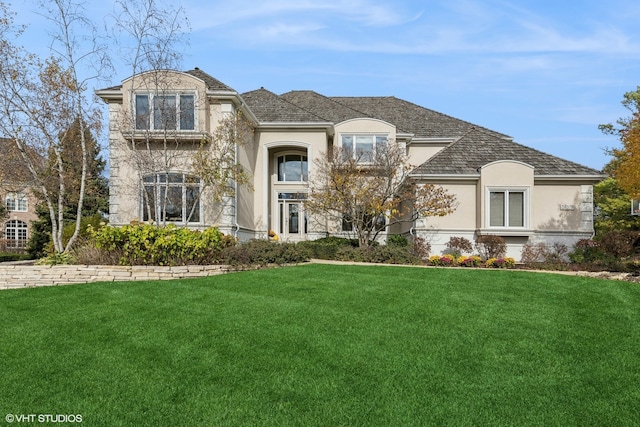 french country home featuring a front lawn