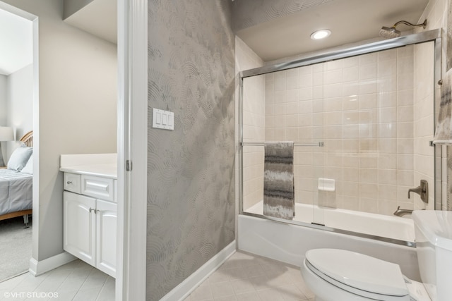 full bathroom featuring tile patterned floors, vanity, toilet, and shower / bath combination with glass door