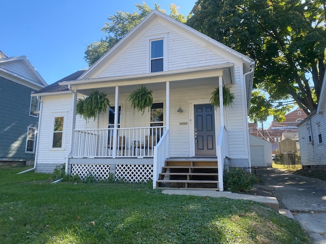 bungalow with a front lawn and a porch