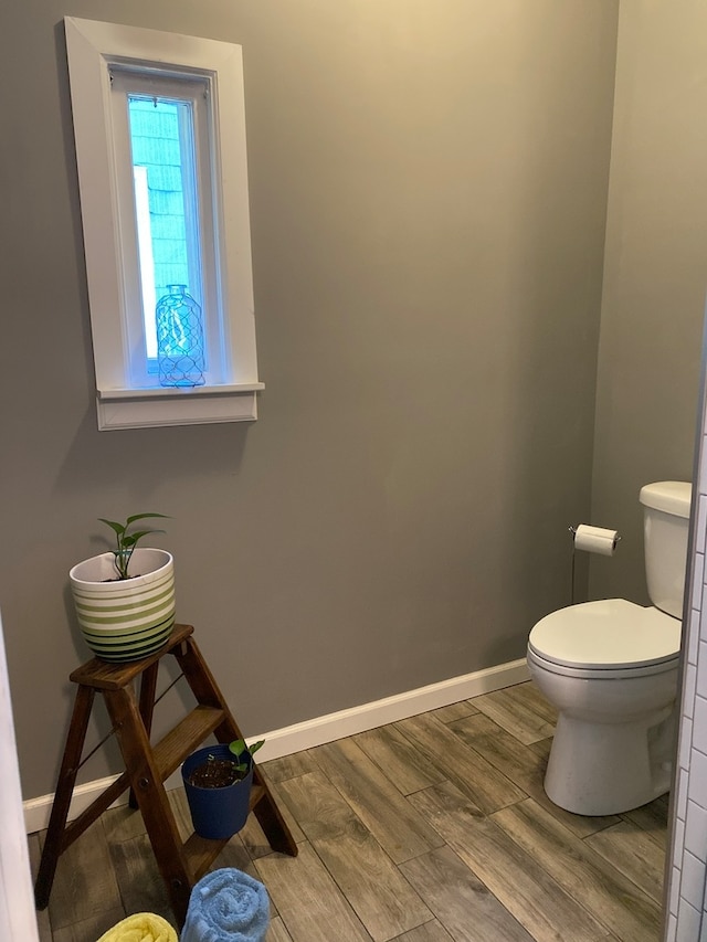 bathroom with hardwood / wood-style floors and toilet