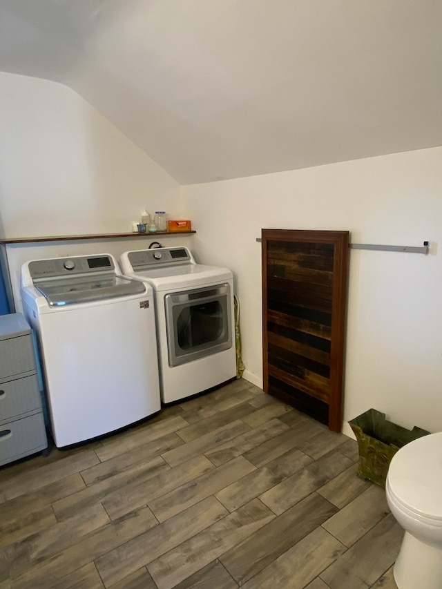 laundry area featuring dark hardwood / wood-style floors and washer and clothes dryer