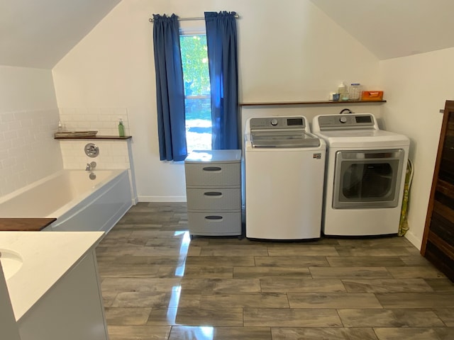 clothes washing area featuring washer and dryer and dark hardwood / wood-style floors